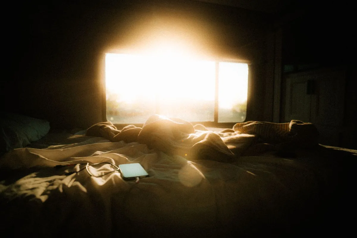 Morning sunlight streaming into a bedroom: the start of a natural sleep routine